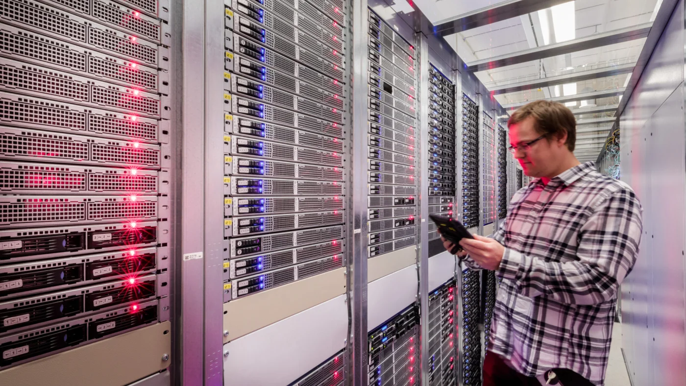 A technician inspects server racks inside an IONOS data center